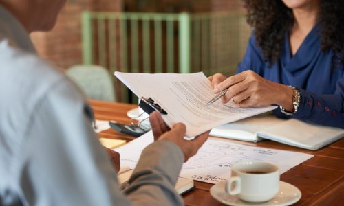 Businessman consulting with lawyer before signing contract